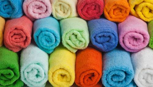Set of colored towels on white background.