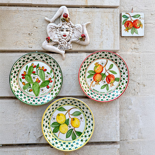 Piatti in ceramica siciliana decorati con limoni, fichi d’India e melagrane, con Trinacria