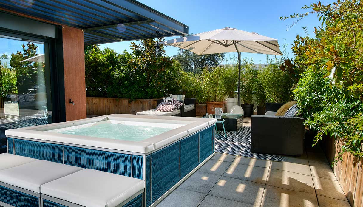 Minipiscina Ninfea Thiny blu con sedute integrate su terrazza arredata