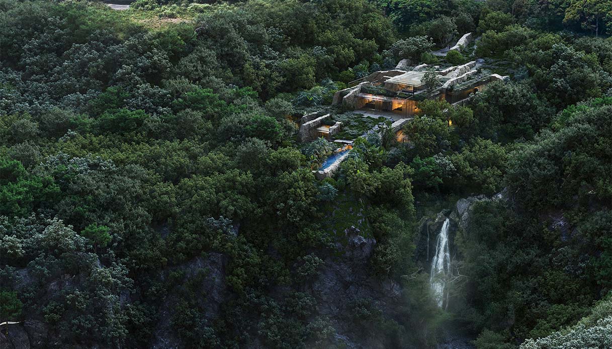 Vista aerea della villa immersa nella foresta di Yakushima, accanto a una cascata naturale