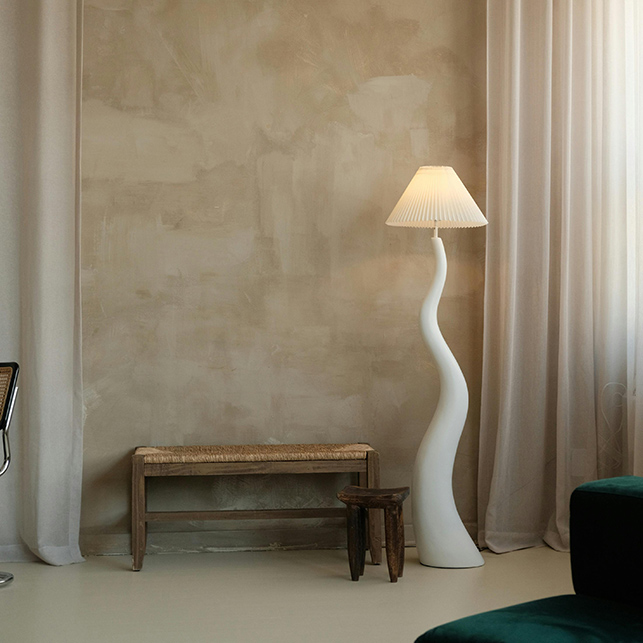 Lampada organica e panca in legno davanti a parete materica Wabi-sabi