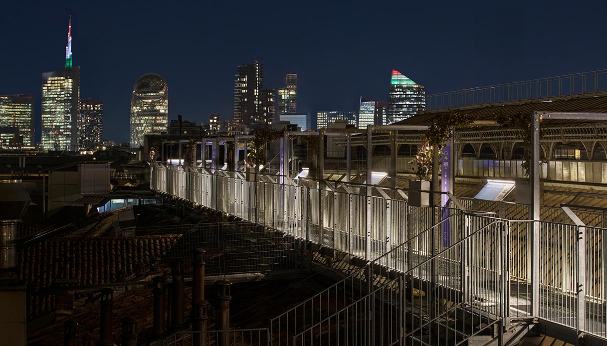 skyline milano di notte visto dalla highline milano con passerella illuminata