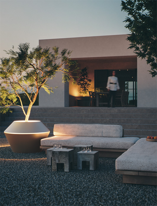 Vaso outdoor Oyster di Christophe Scheyvaerts con illuminazione led interna al crepuscolo, accanto a un divano lounge in giardino