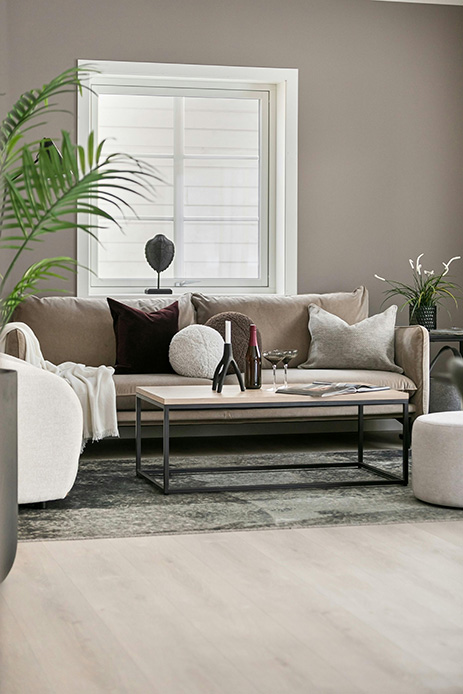 Tavolino da salotto con struttura in metallo in soggiorno dai toni neutri con piante