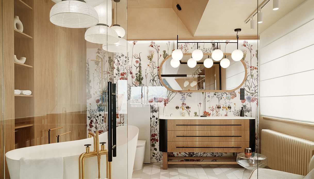 Bagno con vasca freestanding, rubinetteria in ottone, murale ceramico botanico e mobile lavabo in rovere