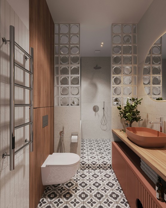 Bagno stretto con doccia aperta tra due pareti in vetrocemento, pavimento in cementine a motivo floreale, mobile in legno e lavabo d’appoggio color terracotta